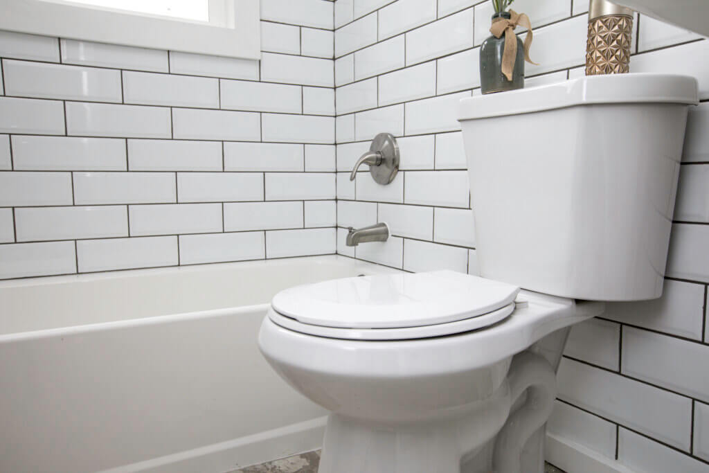 High-Efficiency Toilet Next To Shower | Plumbers 911 | Contractor Referral Service
