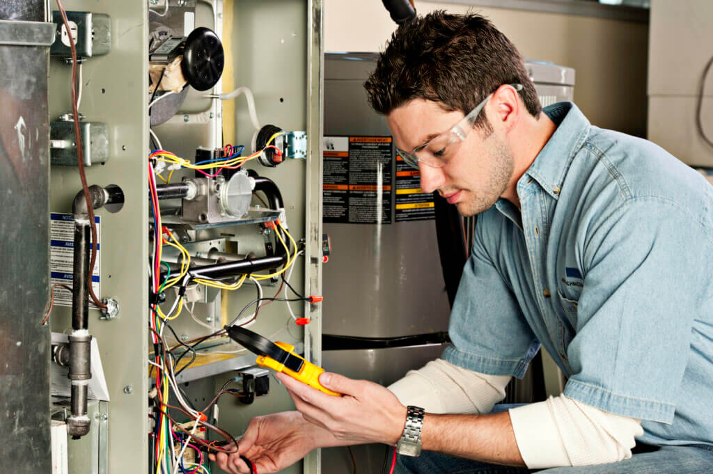 HVAC Service technician testing a furnace | Plumbers 911 | Contractor Referral Service
