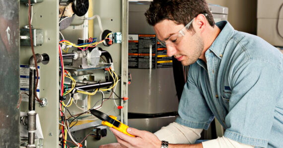 HVAC Service technician testing a furnace | Plumbers 911 | Contractor Referral Service